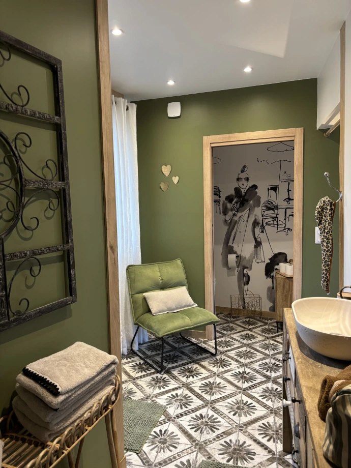 La salle d’eau ouverte sur la chambre apporte une touche originale et moderne. Elle comprend une grande douche (petite marche), un meuble vasque et un WC séparé, dans un esprit à la fois pratique et esthétique.